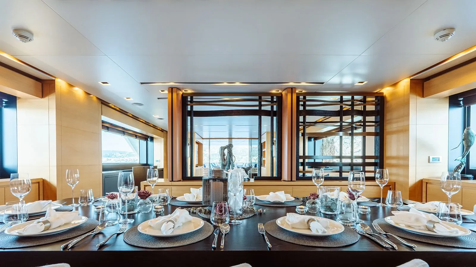 a table set with plates and glasses aboard AWAY Yacht for Charter