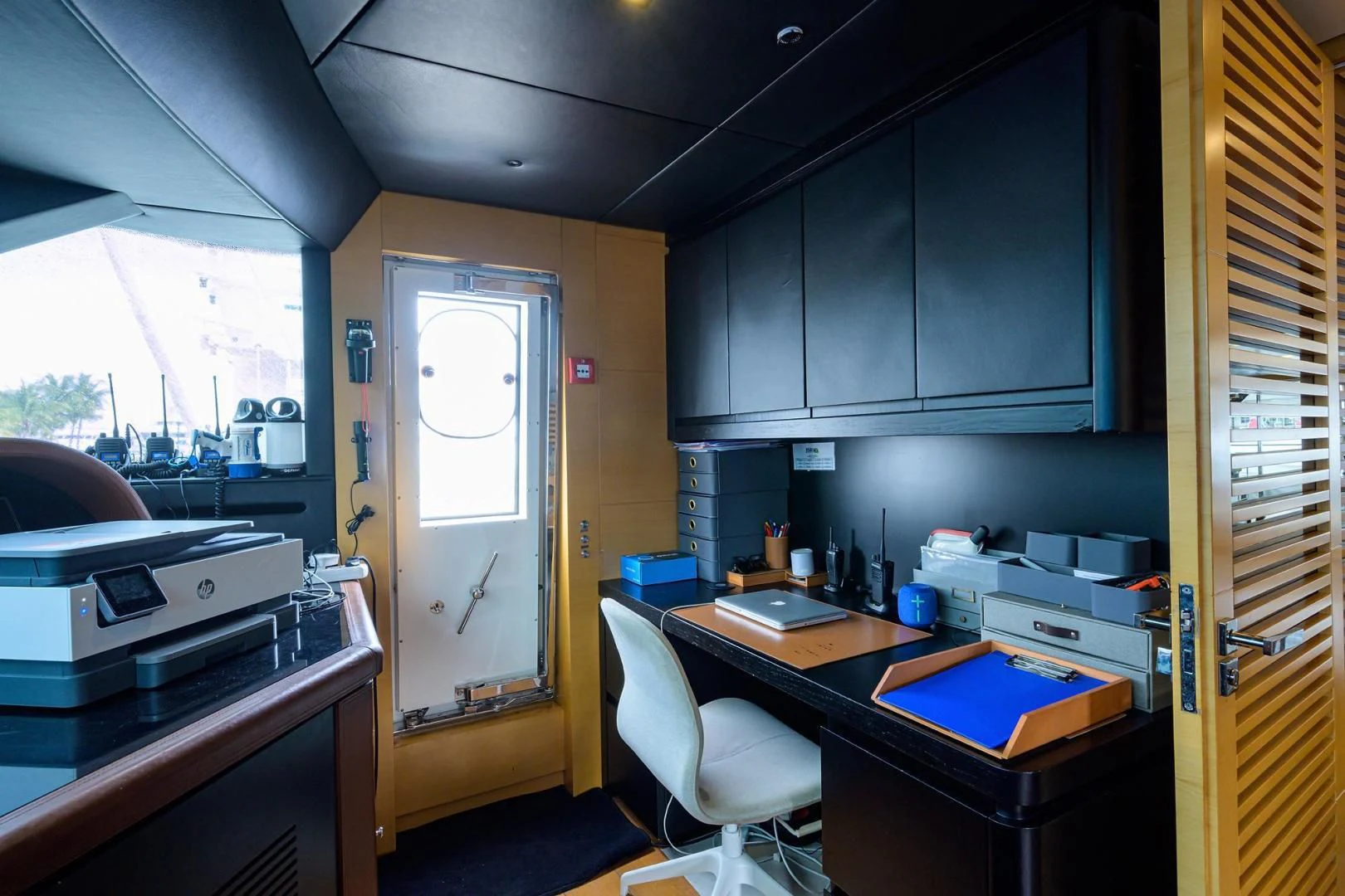 a small kitchen with a white door aboard AWAY Yacht for Charter