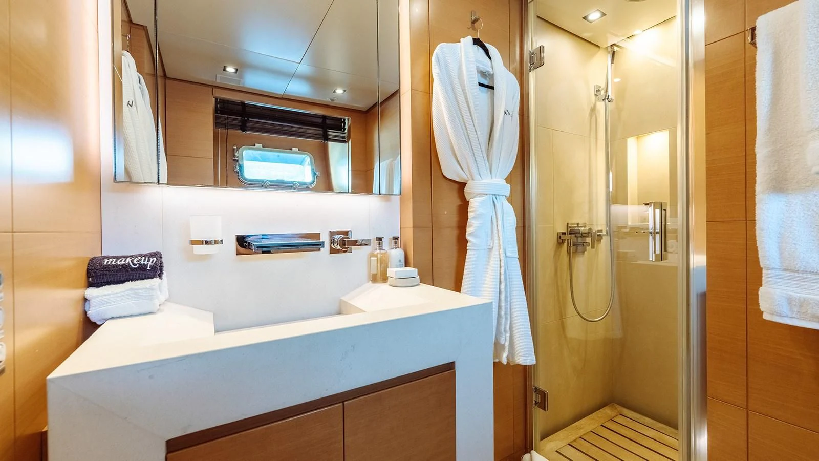 a bathroom with a robe on the wall aboard AWAY Yacht for Charter
