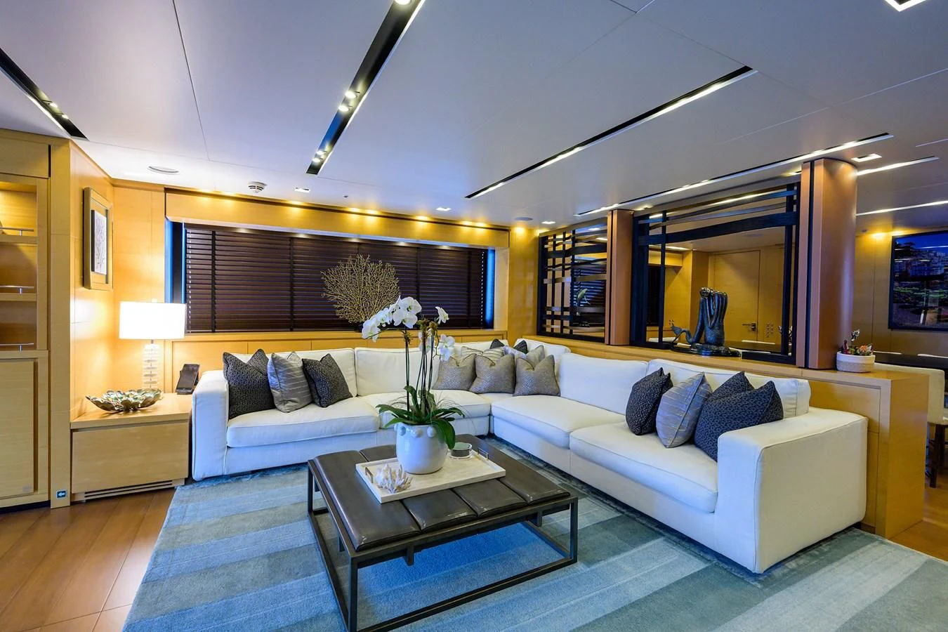 a living room with a large sofa aboard AWAY Yacht for Charter
