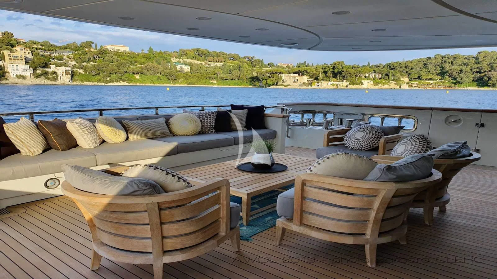 a deck with a view of the water and the land below aboard AWAY Yacht for Charter
