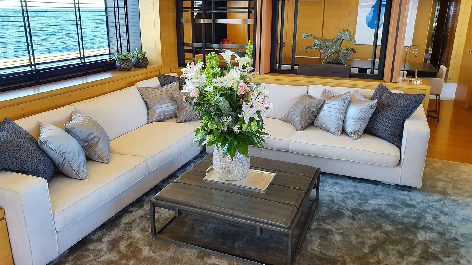 a living room with a couch and a coffee table aboard AWAY Yacht for Charter