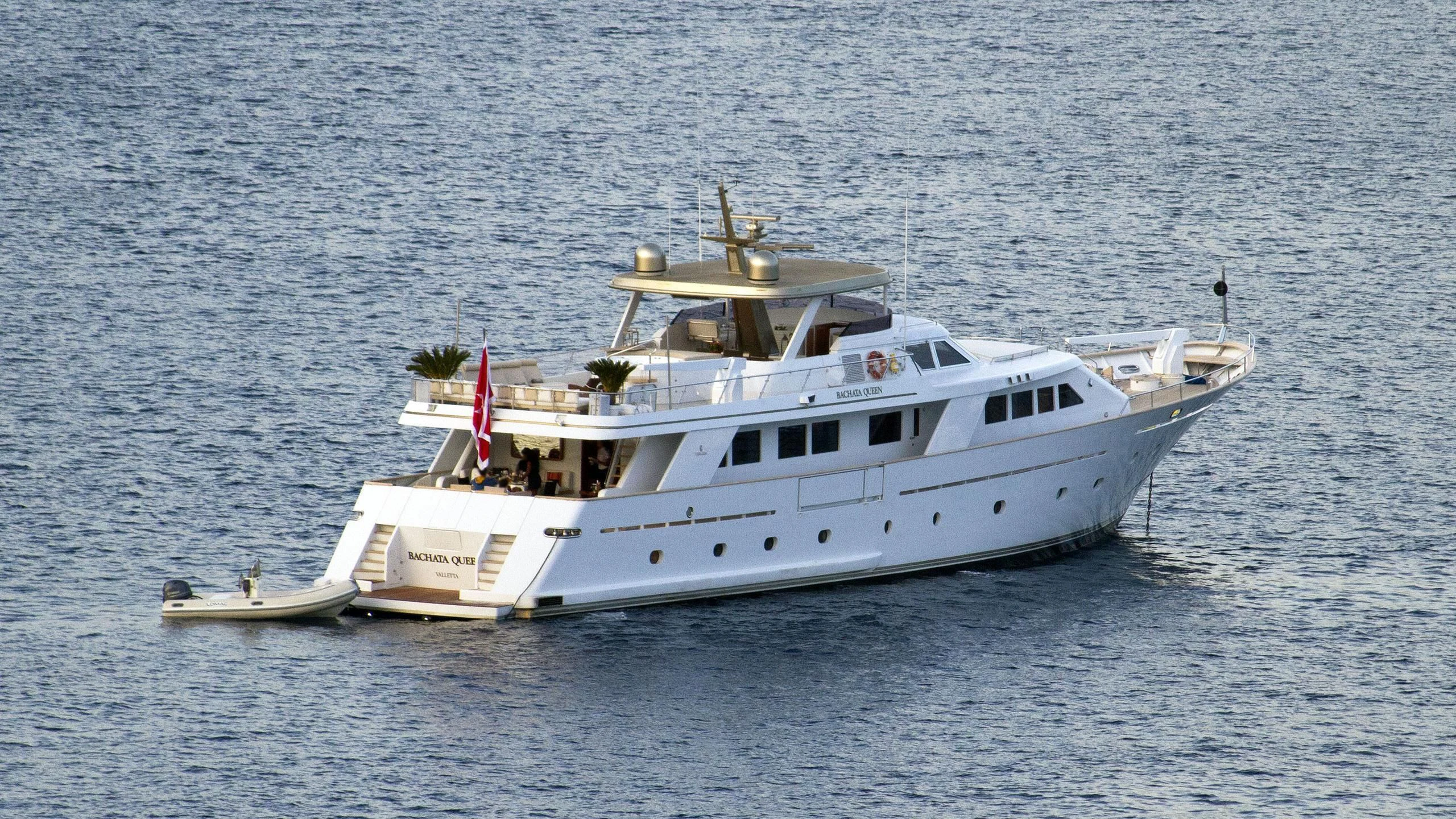 a white boat in the water aboard BACHATA QUEEN Yacht for Sale