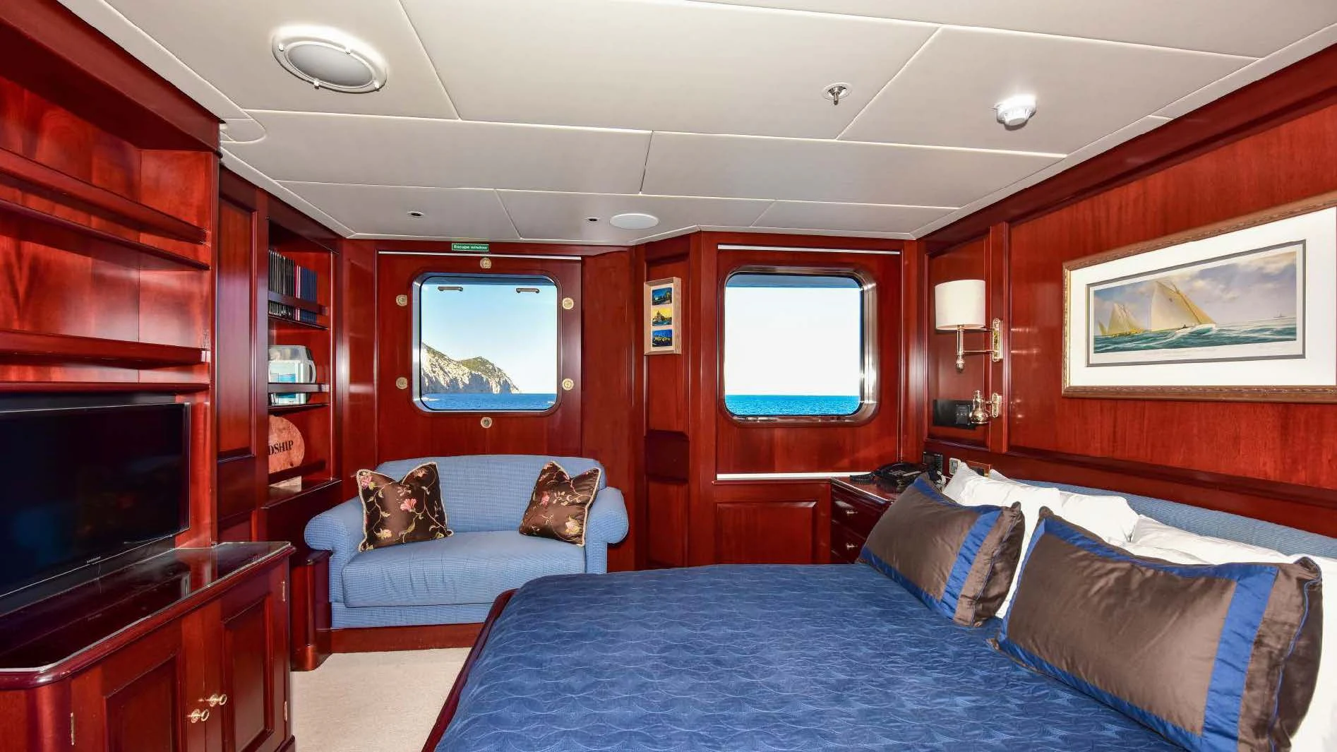 a bedroom with a bed and a television aboard HALCYON Yacht for Sale