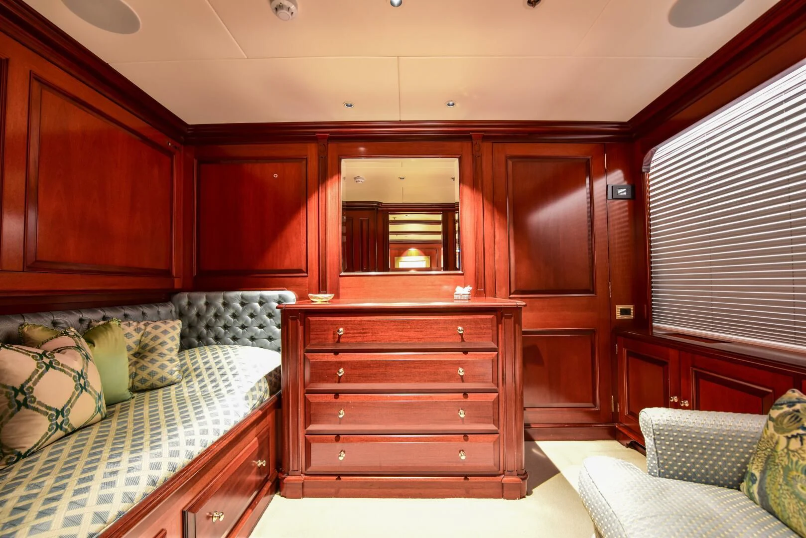 a bedroom with wooden cabinets aboard HALCYON Yacht for Sale