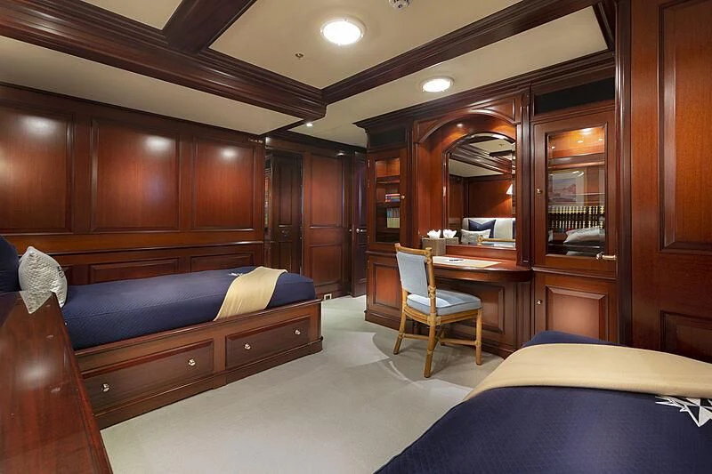 a room with a bed and a chair aboard HALCYON Yacht for Sale