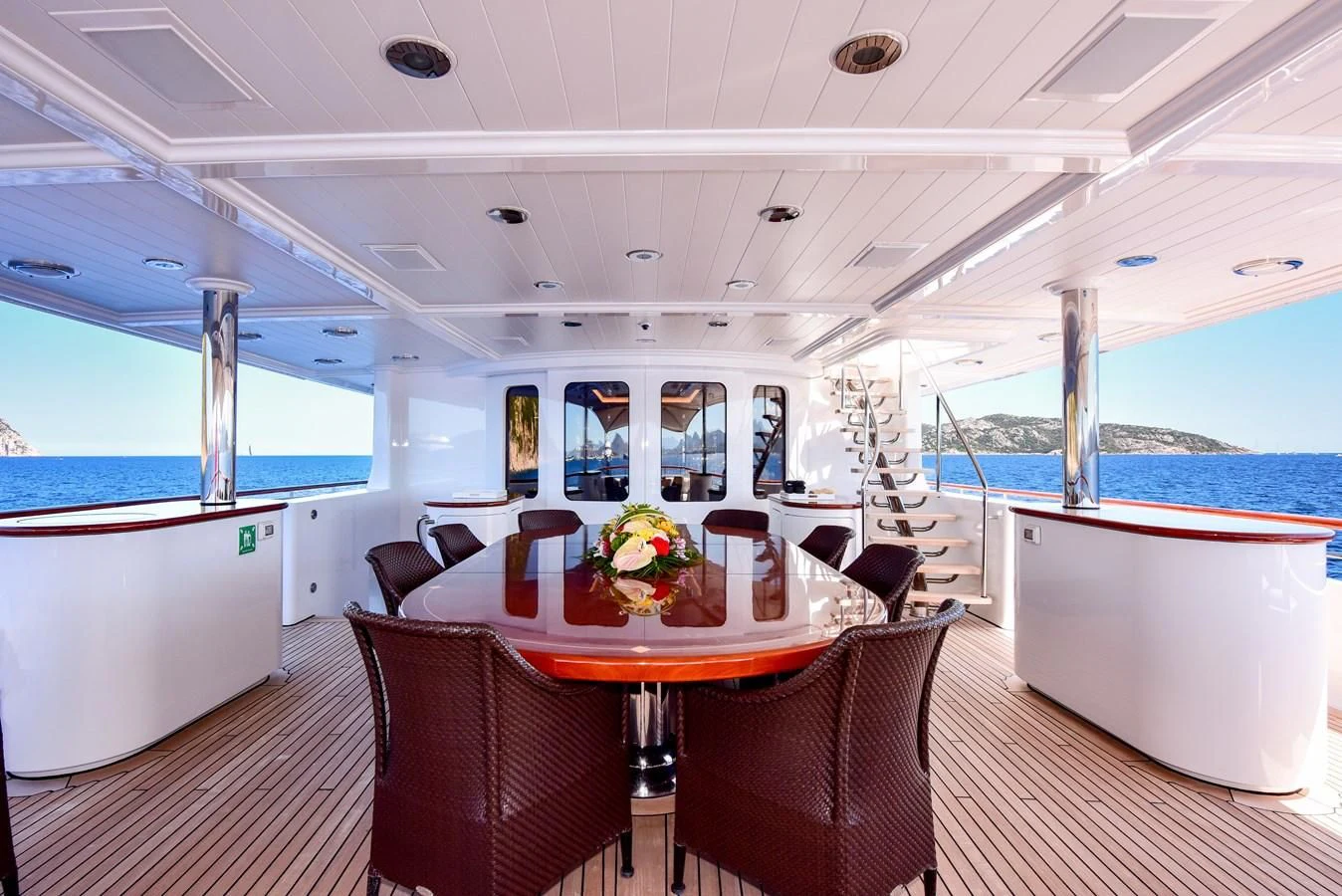 a room with a table chairs and a view of the water aboard HALCYON Yacht for Sale
