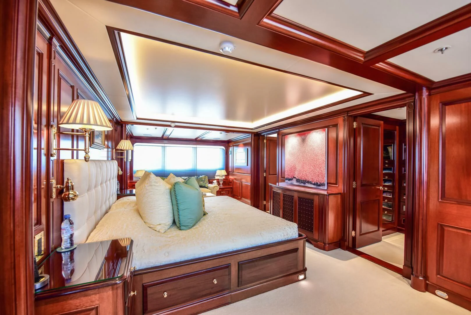 a bedroom with a bed and a mirror aboard HALCYON Yacht for Sale