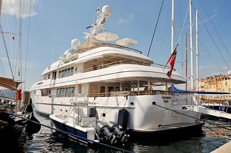 a large white boat in a harbor aboard HALCYON Yacht for Sale