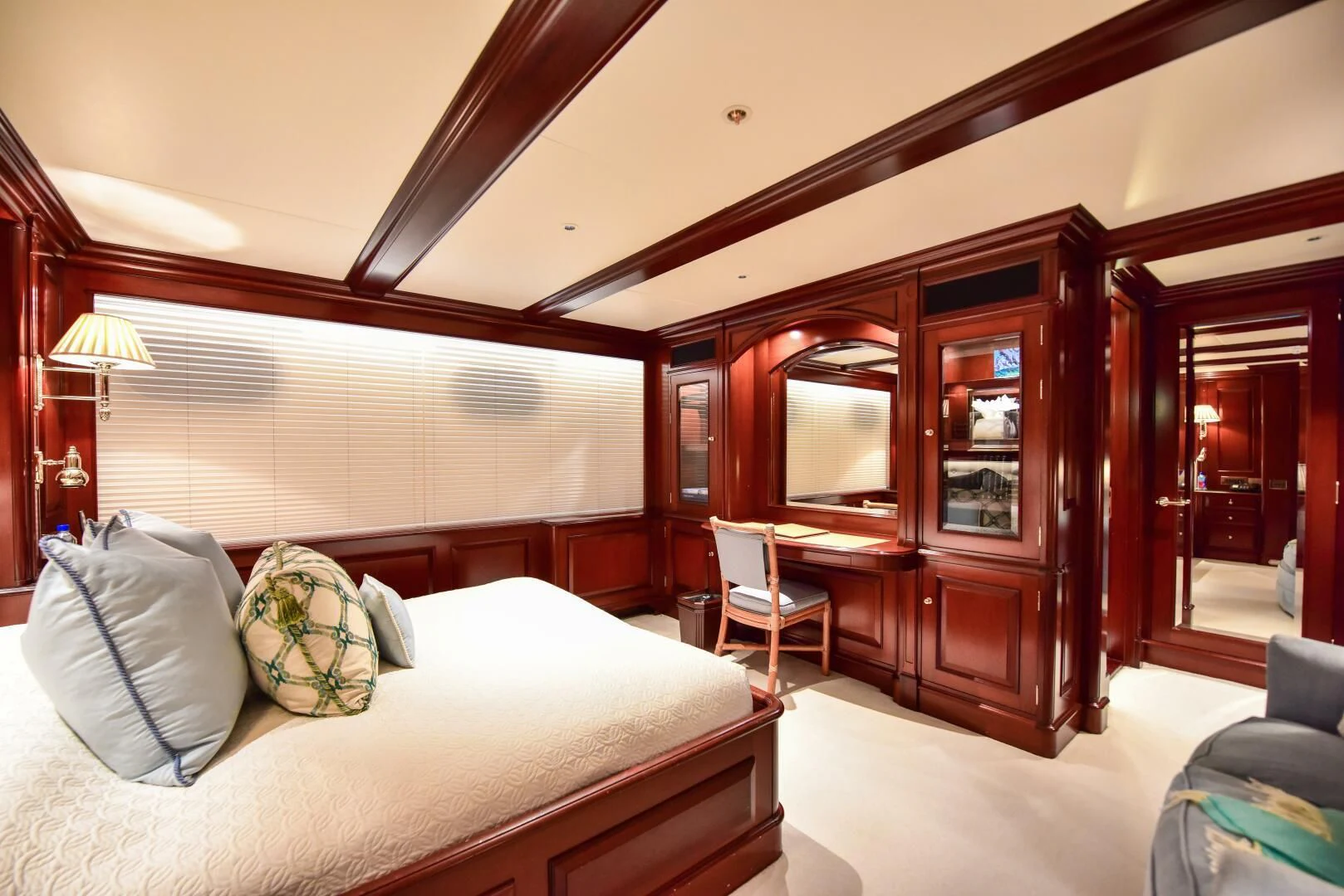 a bedroom with a bed and a chair aboard HALCYON Yacht for Sale