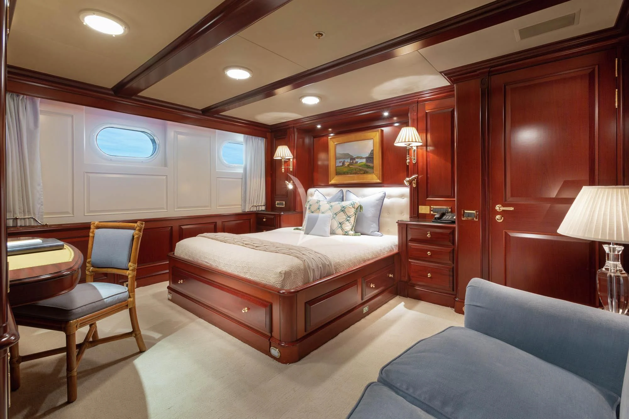 a bedroom with a bed and a desk aboard HALCYON Yacht for Sale