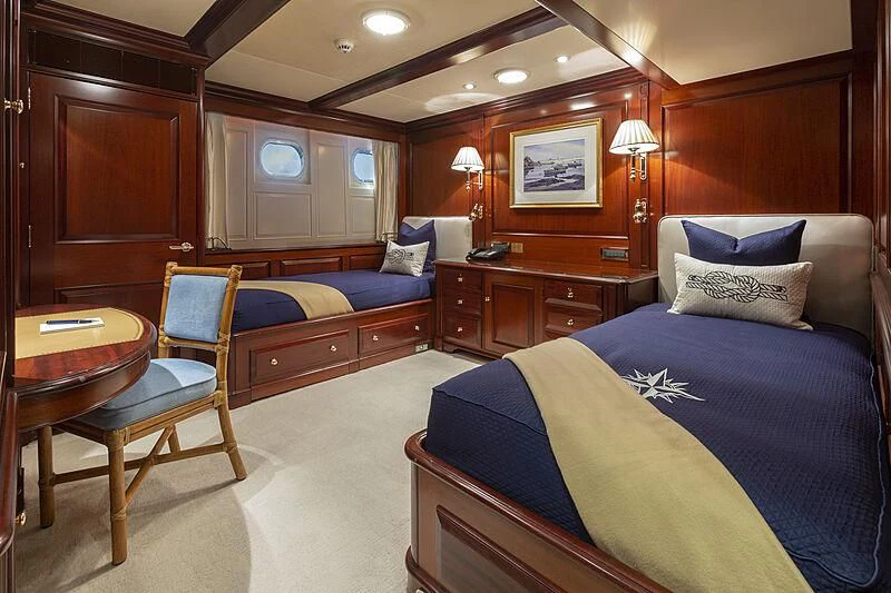 a bedroom with a bed and a chair aboard HALCYON Yacht for Sale
