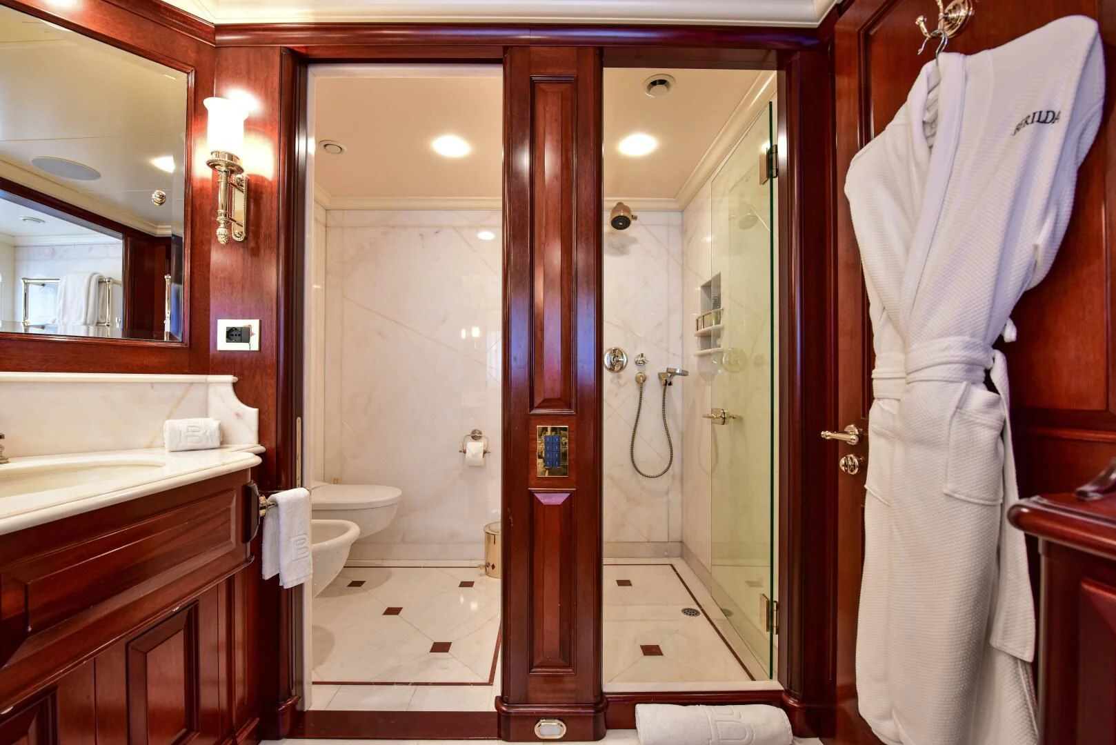 a bathroom with a robe on the wall aboard HALCYON Yacht for Sale