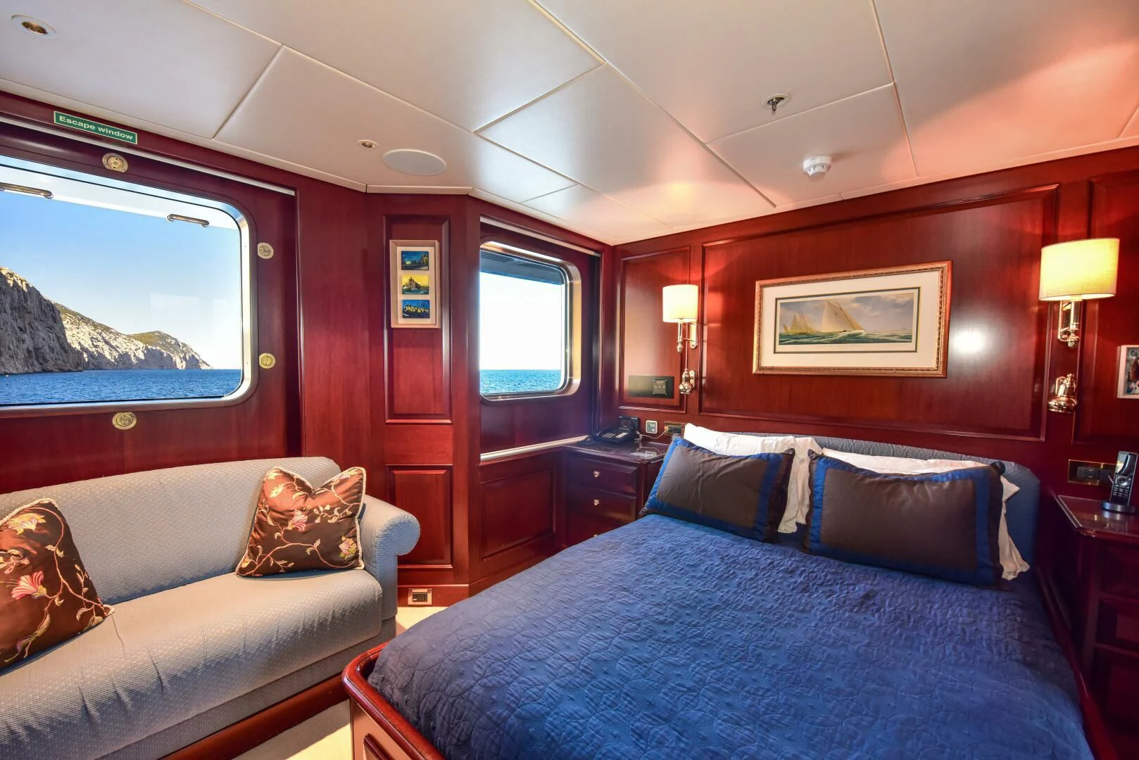 a bedroom with a bed and a window aboard HALCYON Yacht for Sale
