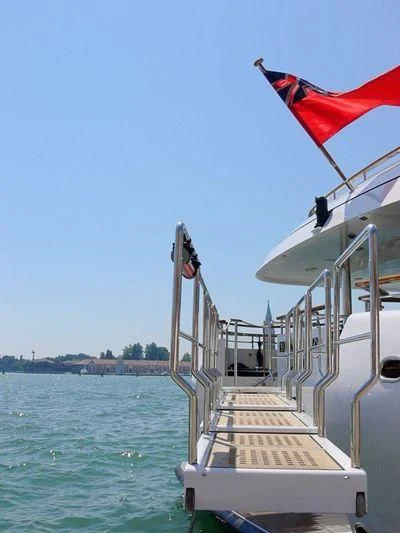 a boat with a flag on the front aboard HALCYON Yacht for Sale