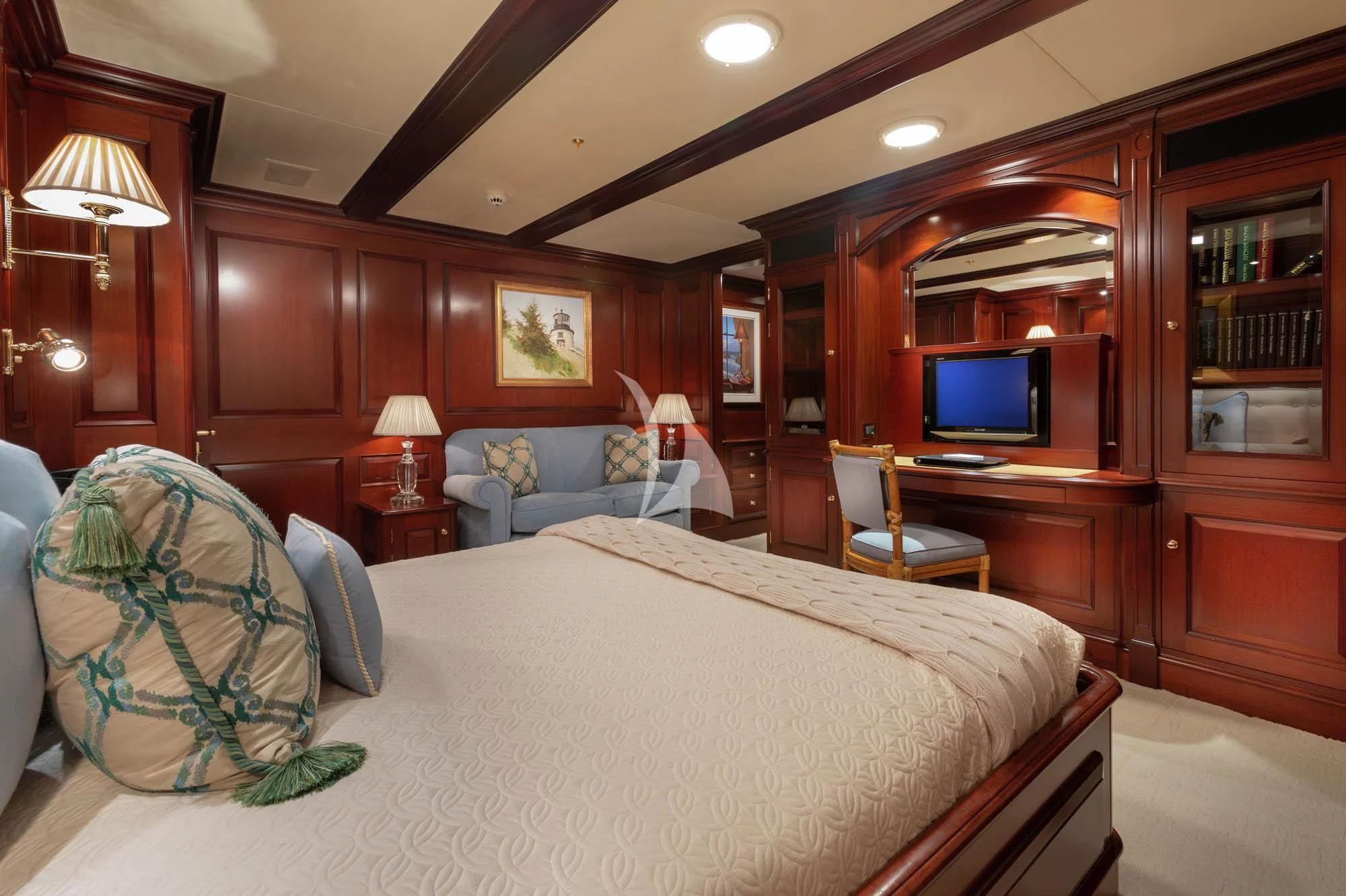 a bedroom with a bed and a desk aboard HALCYON Yacht for Sale