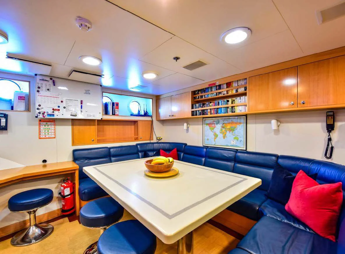 a room with a couch and a table aboard HALCYON Yacht for Sale