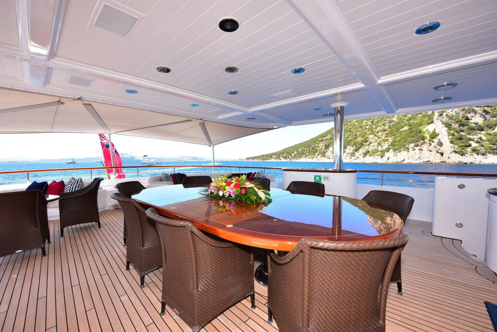 a table and chairs on a deck aboard HALCYON Yacht for Sale