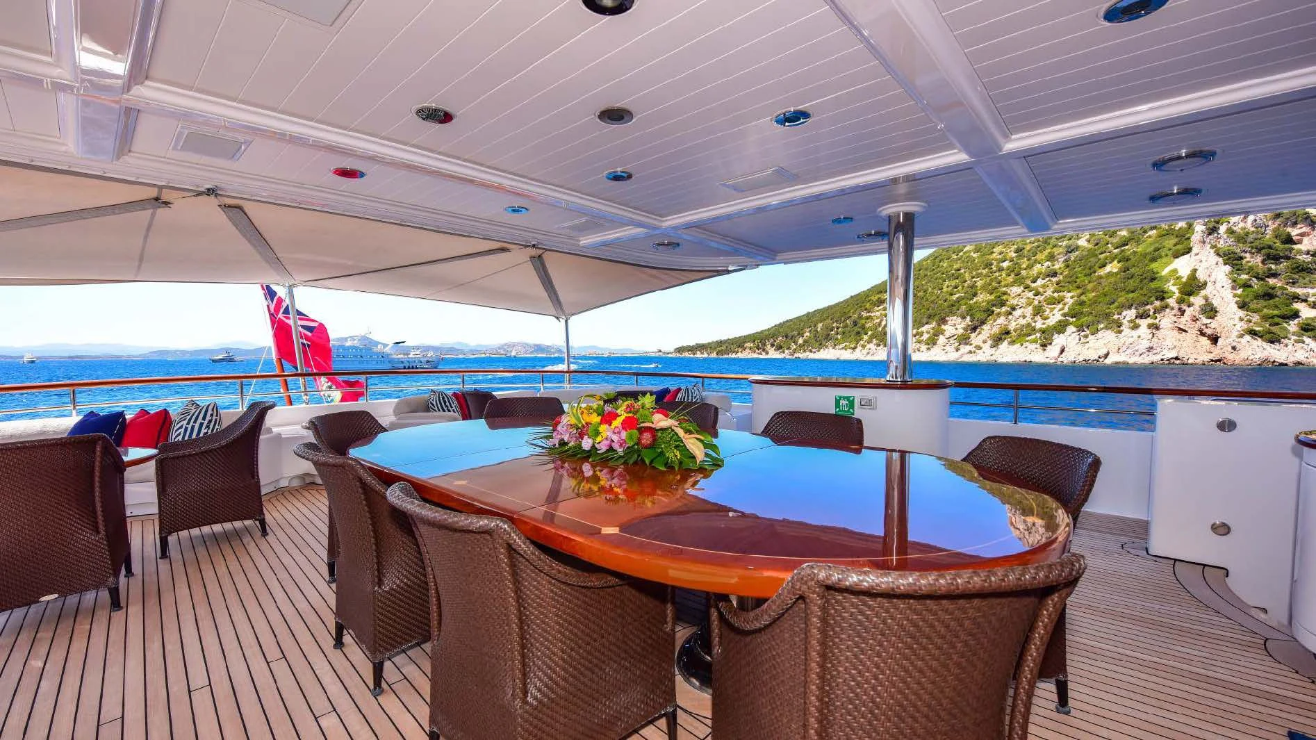 a table and chairs on a deck aboard HALCYON Yacht for Sale