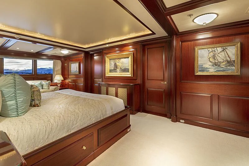 a room with a bed and a dresser aboard HALCYON Yacht for Sale