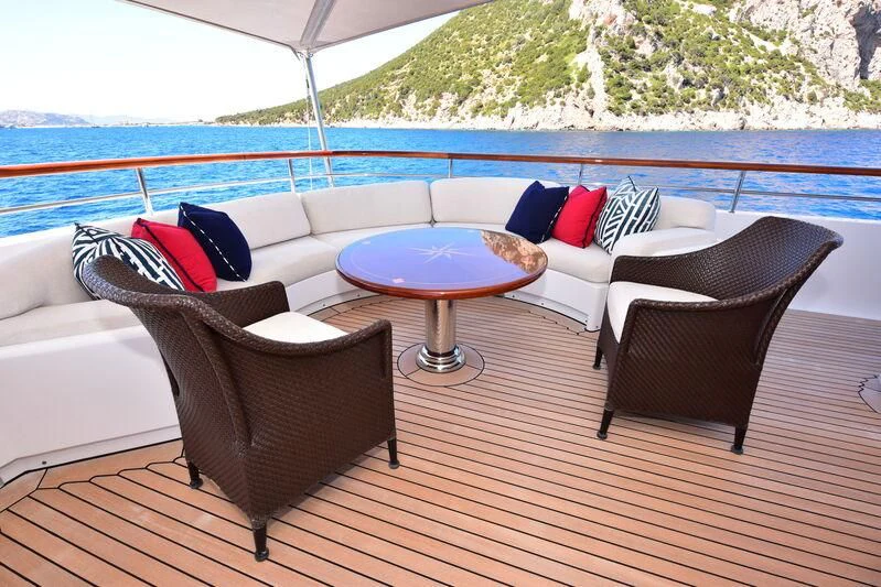 a couch and a table on a deck aboard HALCYON Yacht for Sale