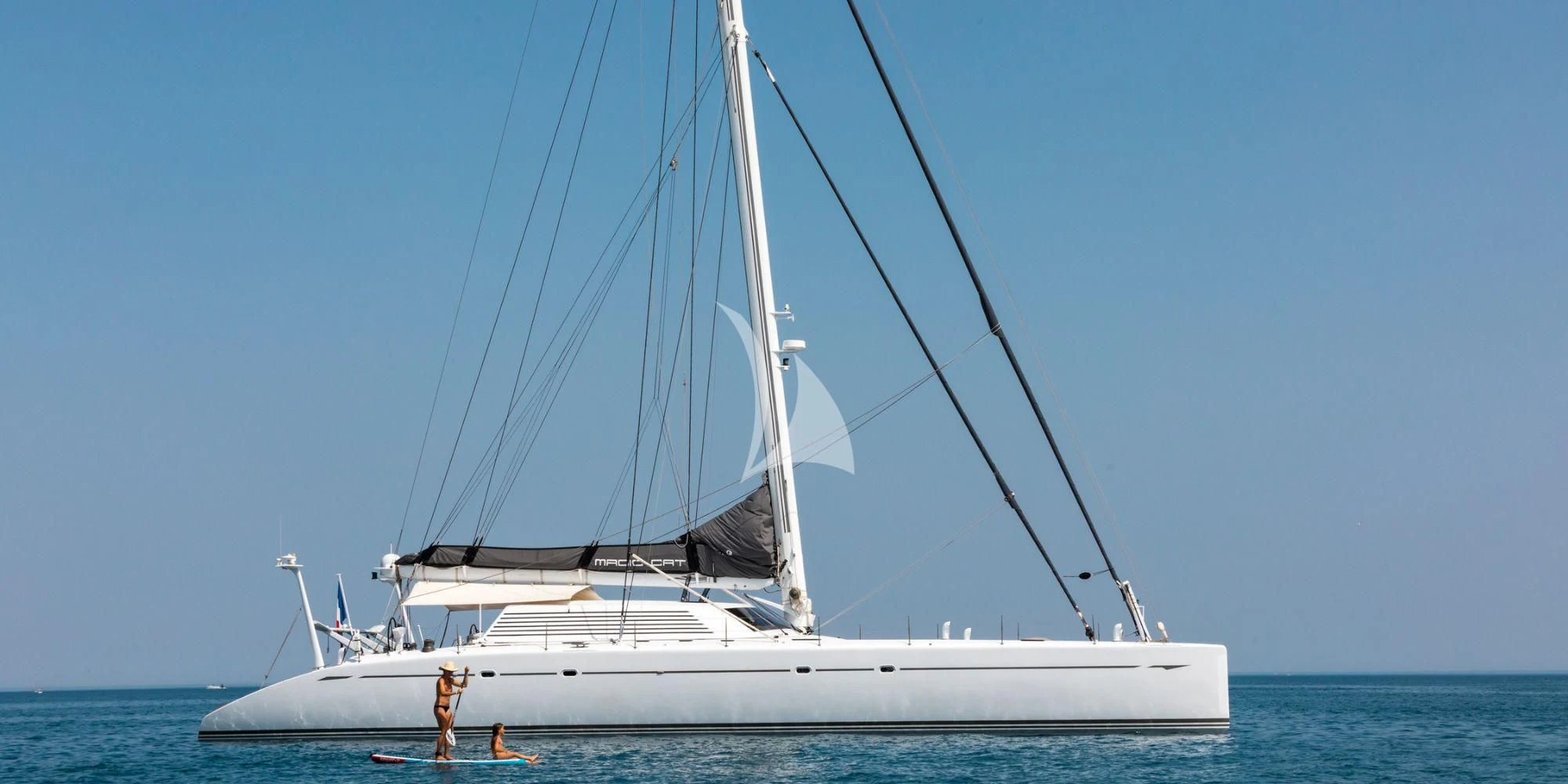 a white boat on the water aboard MAGIC CAT Yacht for Sale