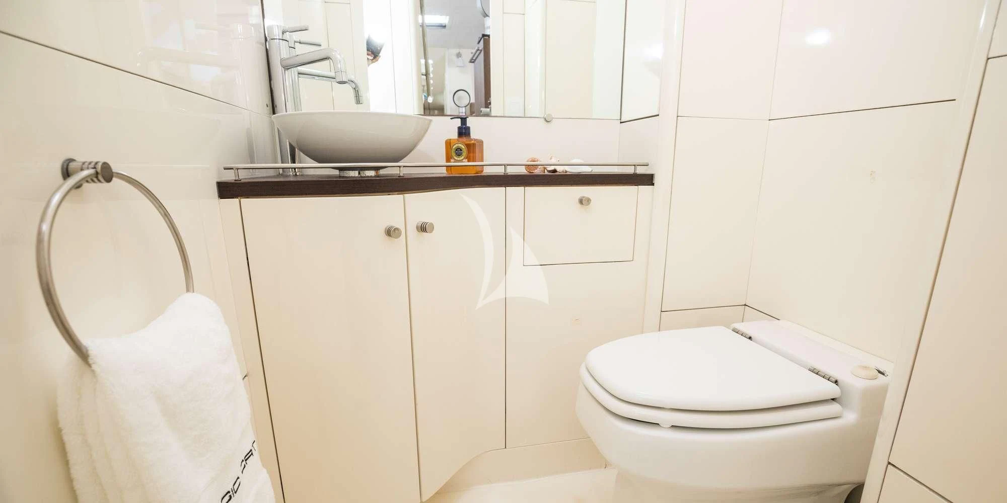 a bathroom with a toilet and sink aboard MAGIC CAT Yacht for Sale