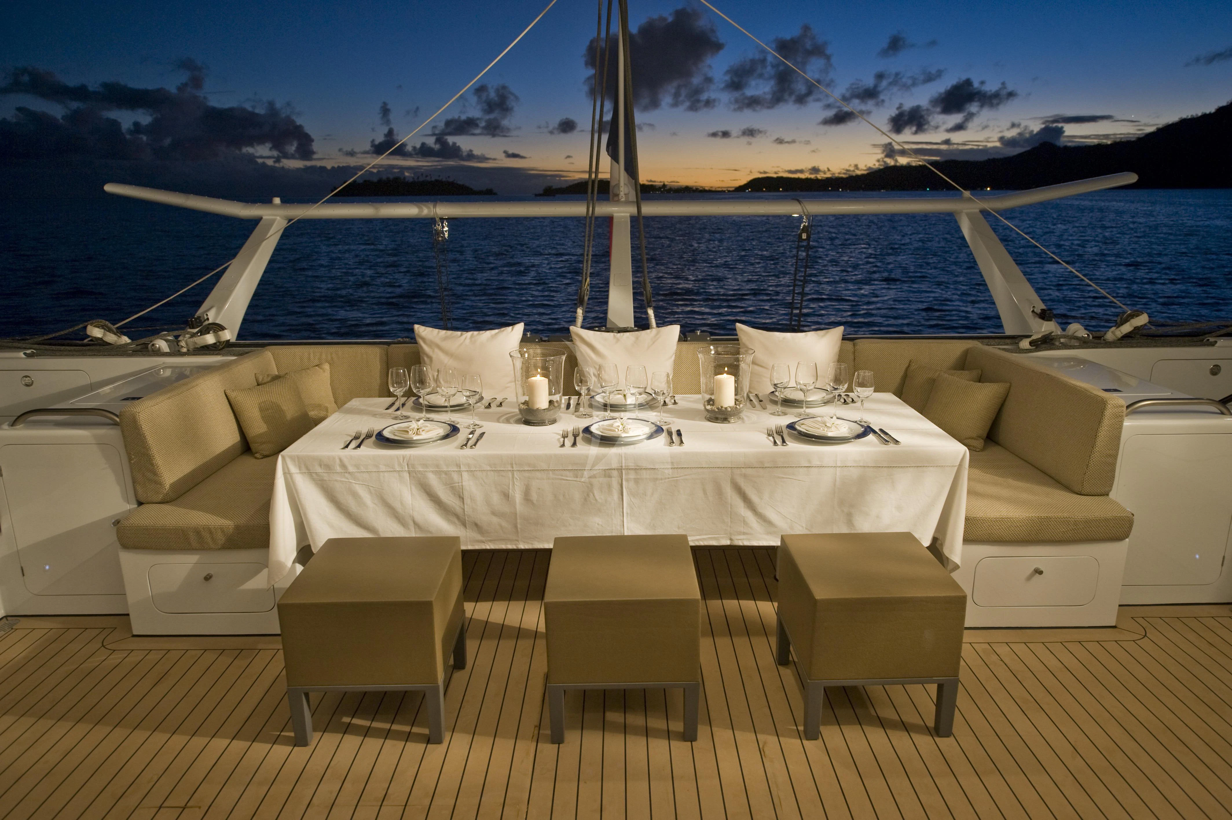 a table set for a dinner on a boat aboard MAGIC CAT Yacht for Sale