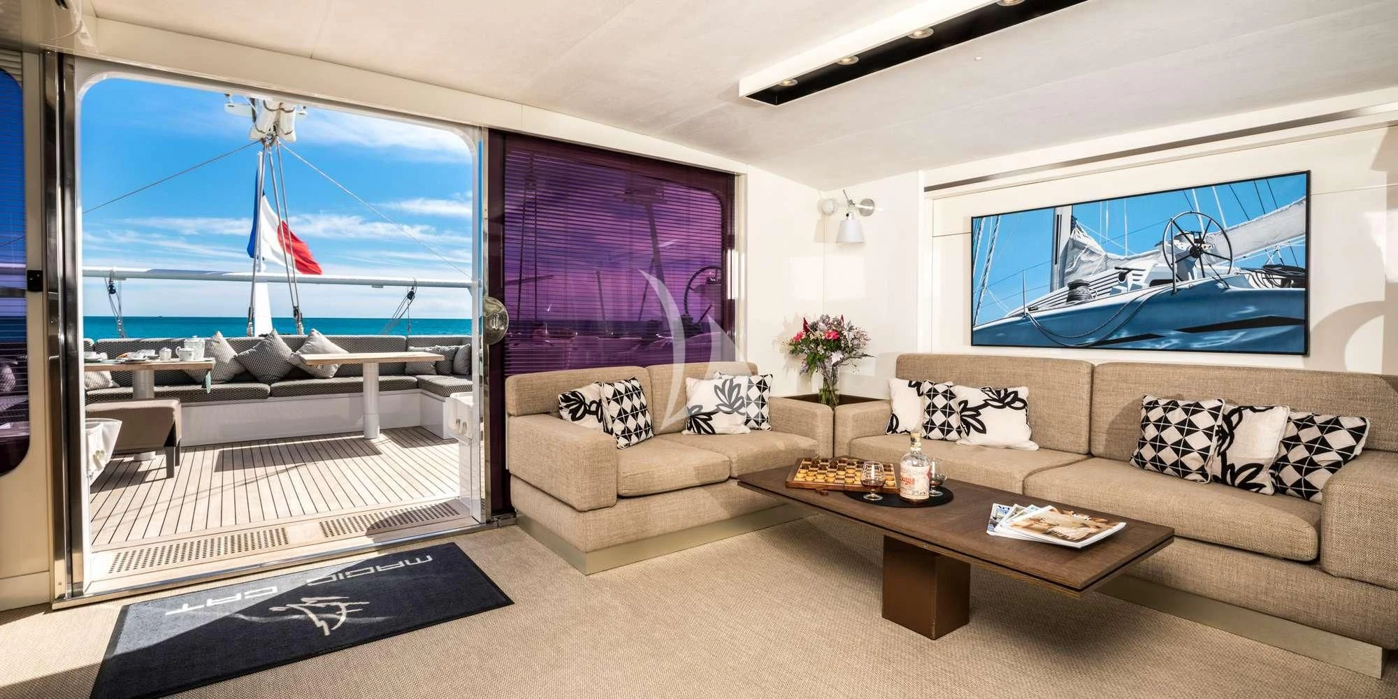 a living room with a large screen aboard MAGIC CAT Yacht for Sale
