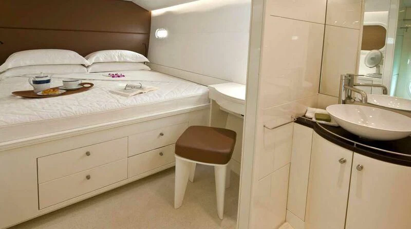 a bed with a sink and a mirror aboard MAGIC CAT Yacht for Sale