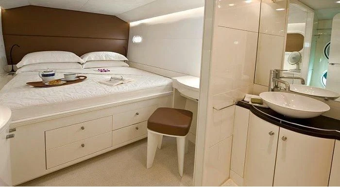 a white bed with a white bed aboard MAGIC CAT Yacht for Sale
