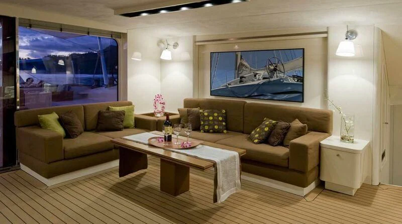 a living room with a couch and a coffee table aboard MAGIC CAT Yacht for Sale