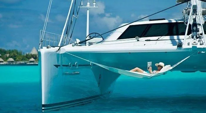 a person in a white boat aboard MAGIC CAT Yacht for Sale