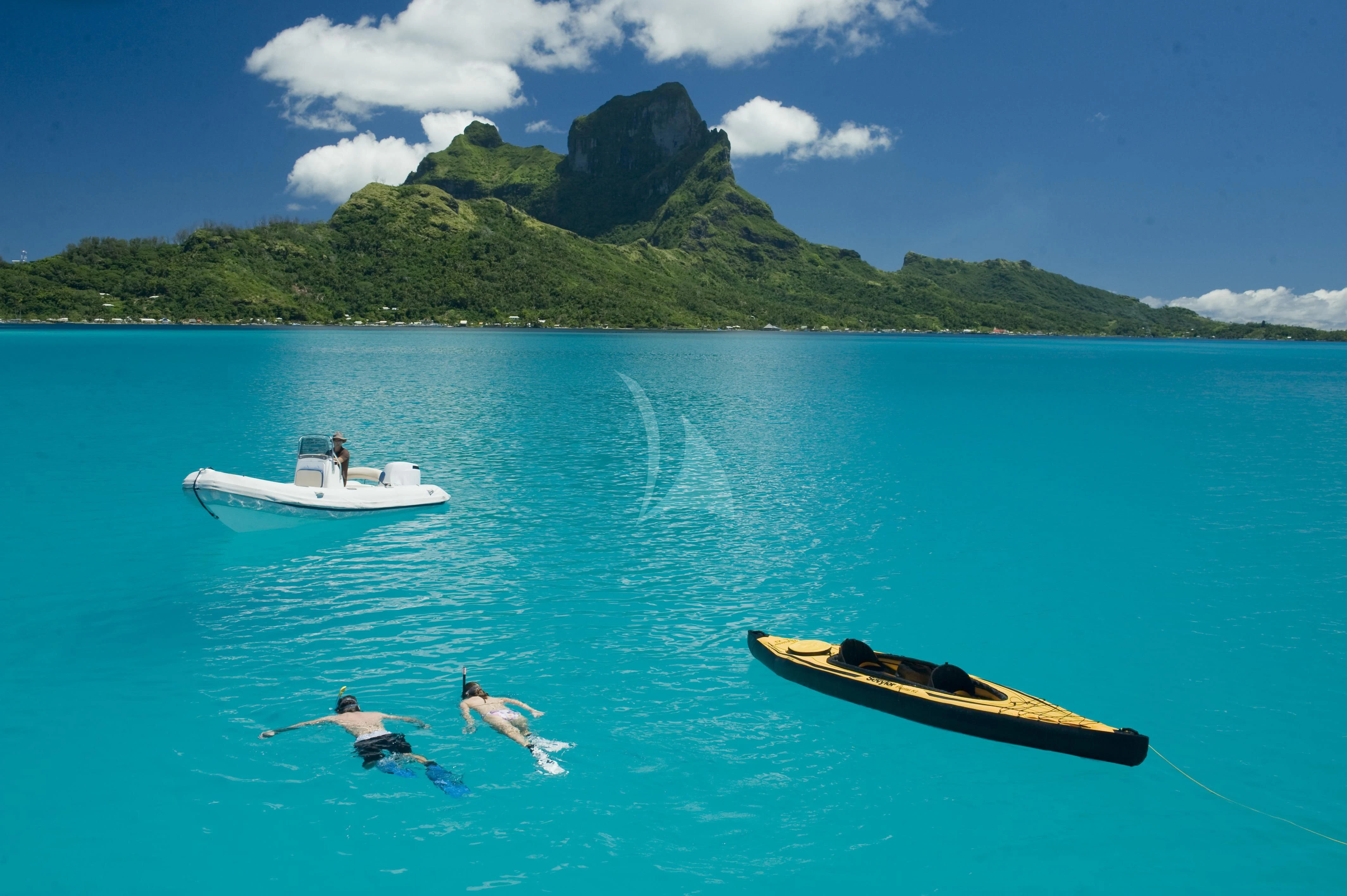 a boat and a couple of boats in the water aboard MAGIC CAT Yacht for Sale
