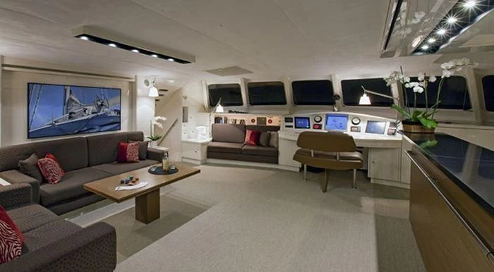a living room with a couch and a tv aboard MAGIC CAT Yacht for Sale