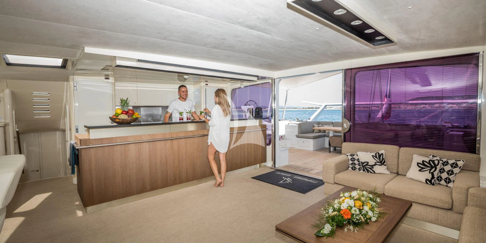 a couple of people in a room aboard MAGIC CAT Yacht for Sale
