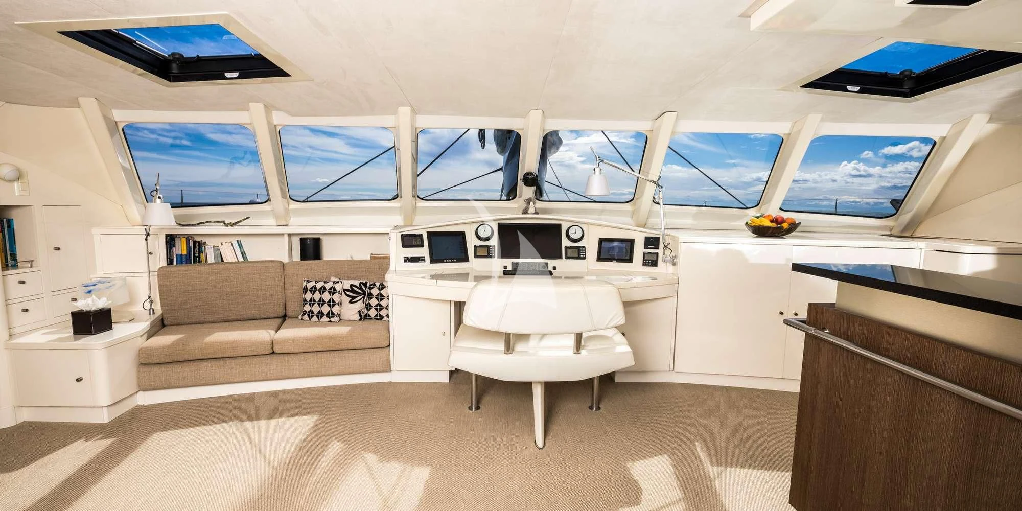 a room with a couch and a table and a window aboard MAGIC CAT Yacht for Sale
