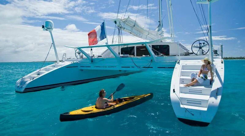 a couple of people in a sailboat on the water aboard MAGIC CAT Yacht for Sale