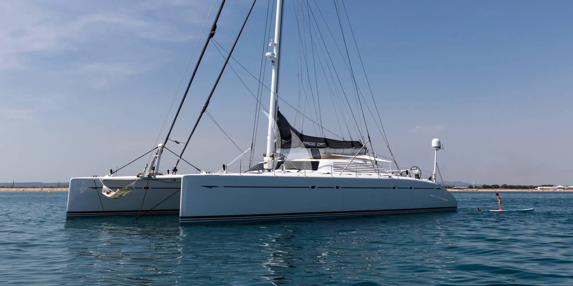 a white boat on the water aboard MAGIC CAT Yacht for Sale