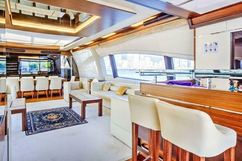 a room with tables chairs and a rug aboard YUZHOU Yacht for Sale