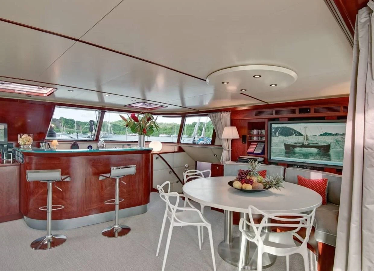 a room with a table and chairs aboard MIROVIA Yacht for Charter