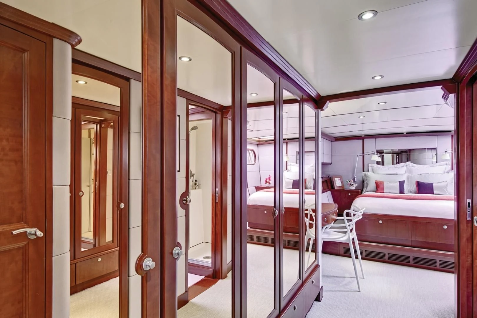 a room with a bed and a closet aboard MIROVIA Yacht for Charter