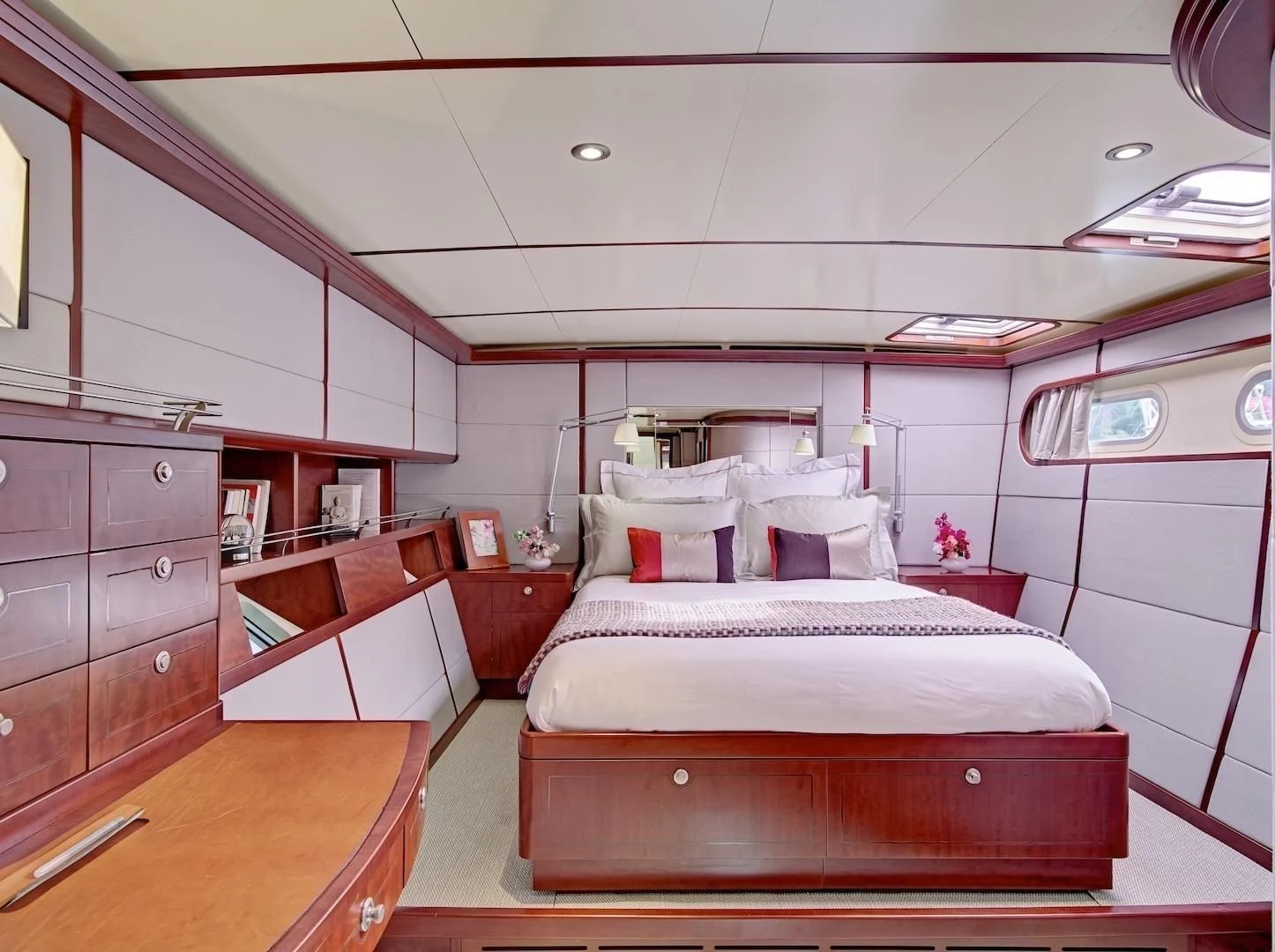 a bedroom with a bed and desk aboard MIROVIA Yacht for Charter