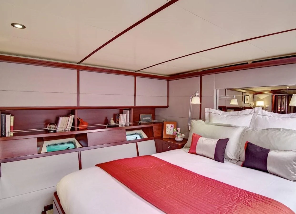a room with a bed and a desk aboard MIROVIA Yacht for Charter