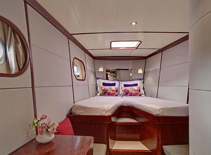 a room with a bed and a table aboard MIROVIA Yacht for Charter