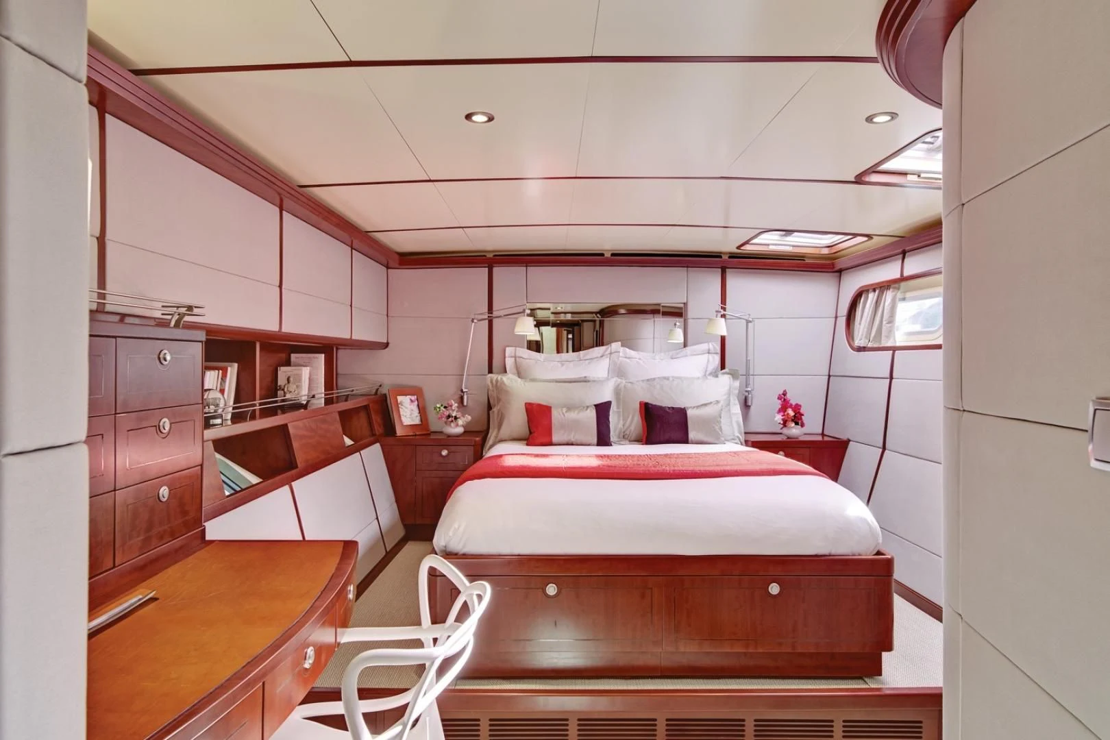 a bedroom with a bed and desk aboard MIROVIA Yacht for Charter