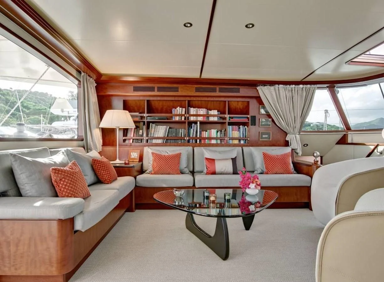a living room with a table and couches aboard MIROVIA Yacht for Charter