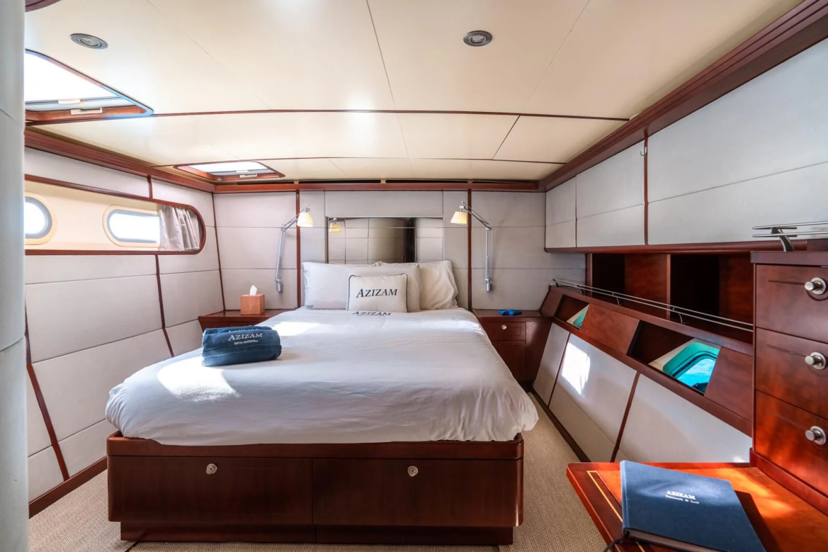 a room with a bed and a desk aboard MIROVIA Yacht for Charter
