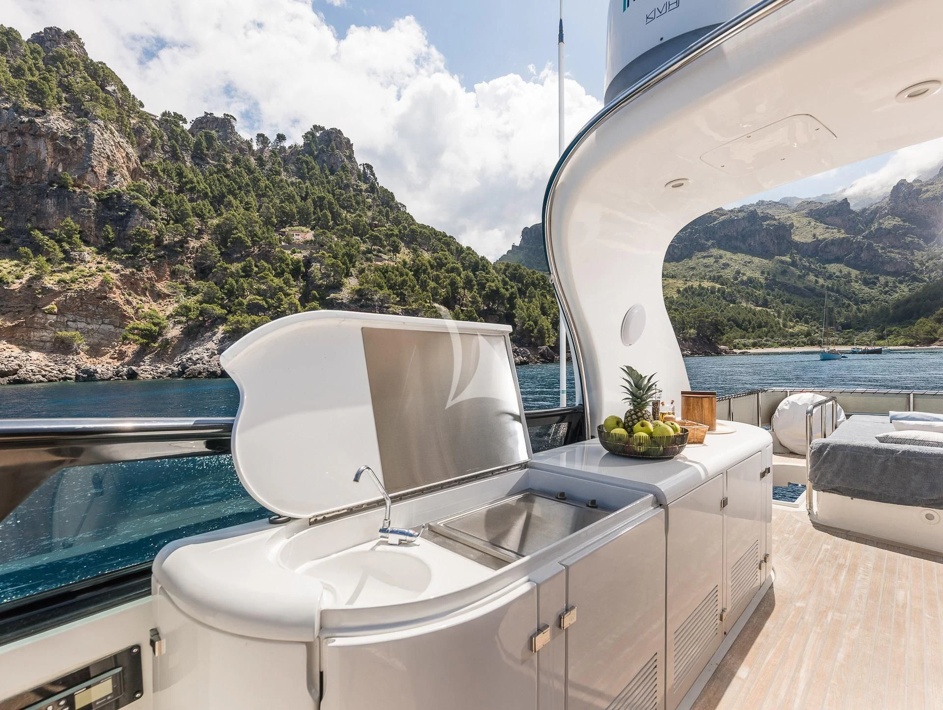 a white bathtub in a room with a large body of water and trees in the background aboard POBEDY I Yacht for Sale
