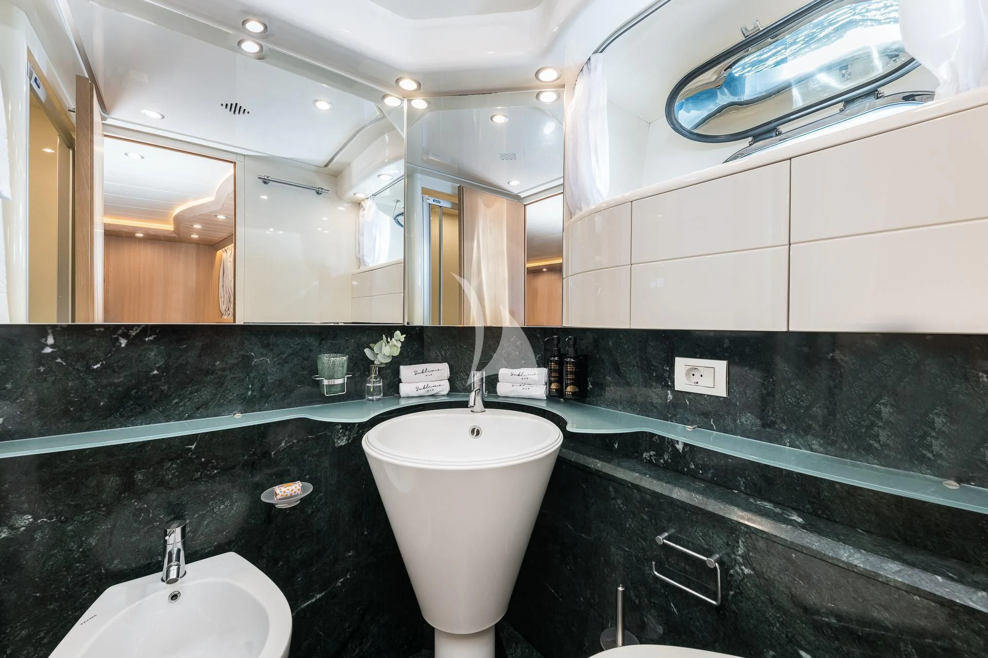 a bathroom with sinks and mirrors aboard POBEDY I Yacht for Sale